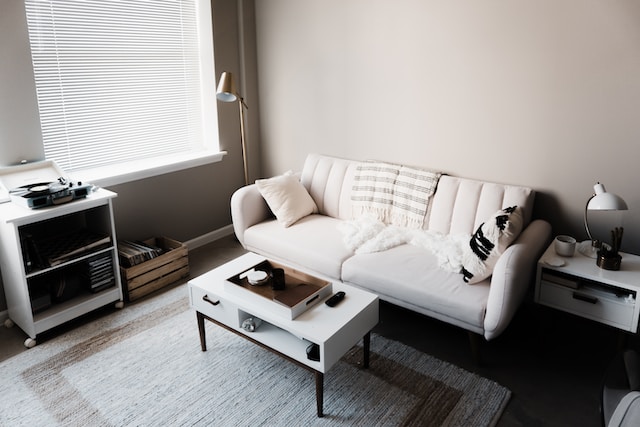 white couch in front of a white wooden table